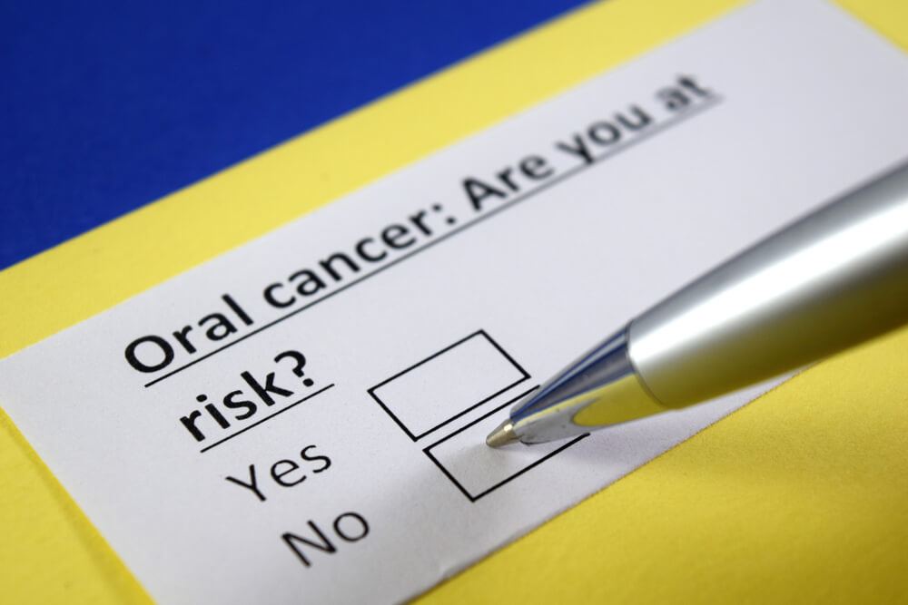 Checking a box under the question "Oral cancer: Are you at risk?"