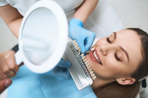 woman choosing veneer shade