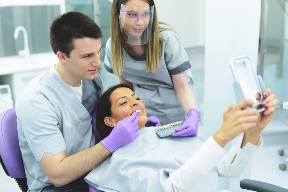Dentists and patient during shade matching