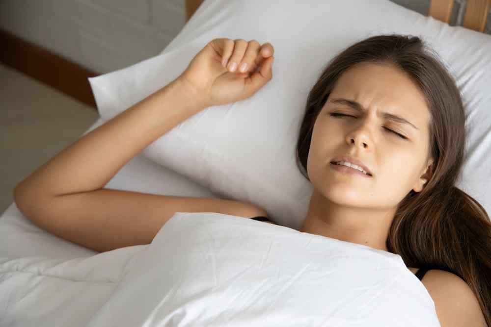 Woman sleeping and grinding her teeth