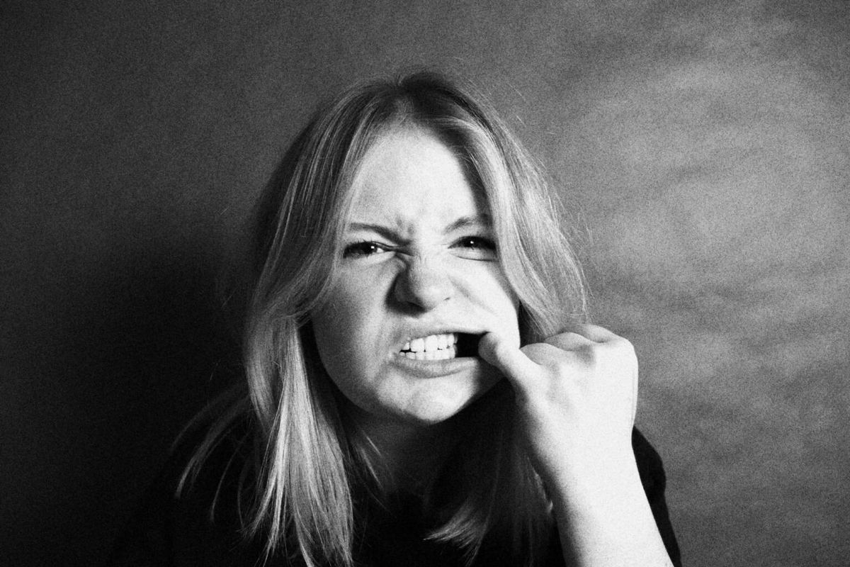 Woman pulling her lip back and gritting her teeth