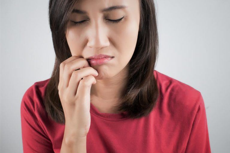 Woman in red shirt with toothache