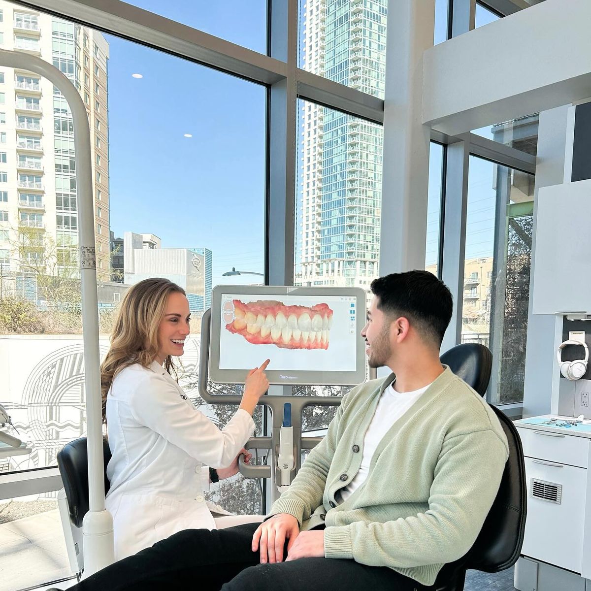Dentist showing scan of teeth to dental patient