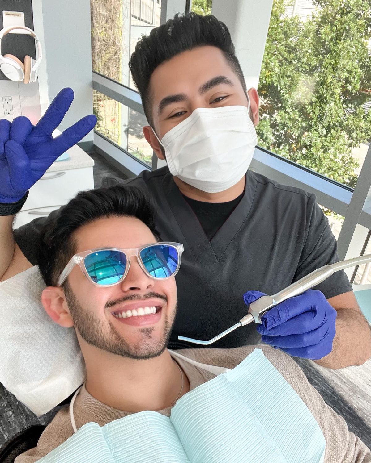 Dental team member in mask with smiling dental patient